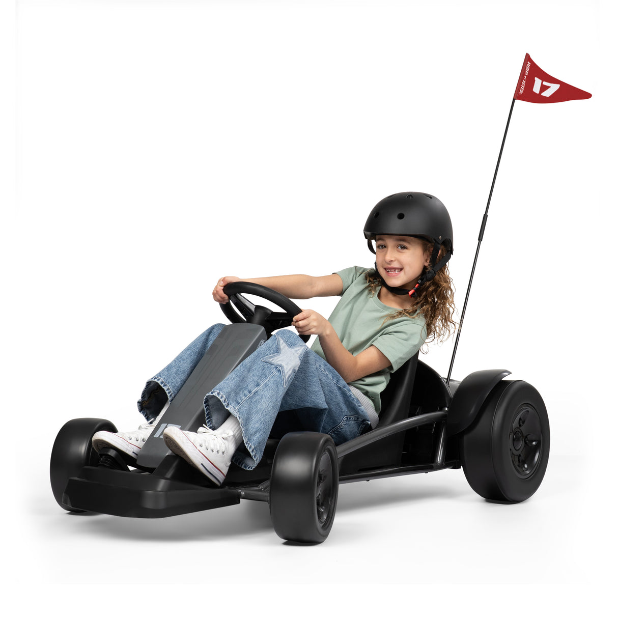 Child driving a black go kart with a red flag on a white background