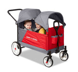 red and gray wagon with two children riding