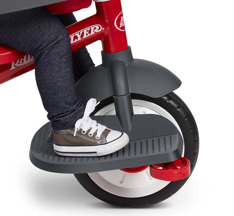 Child Using The Front Wheel Footrest On Their Trike