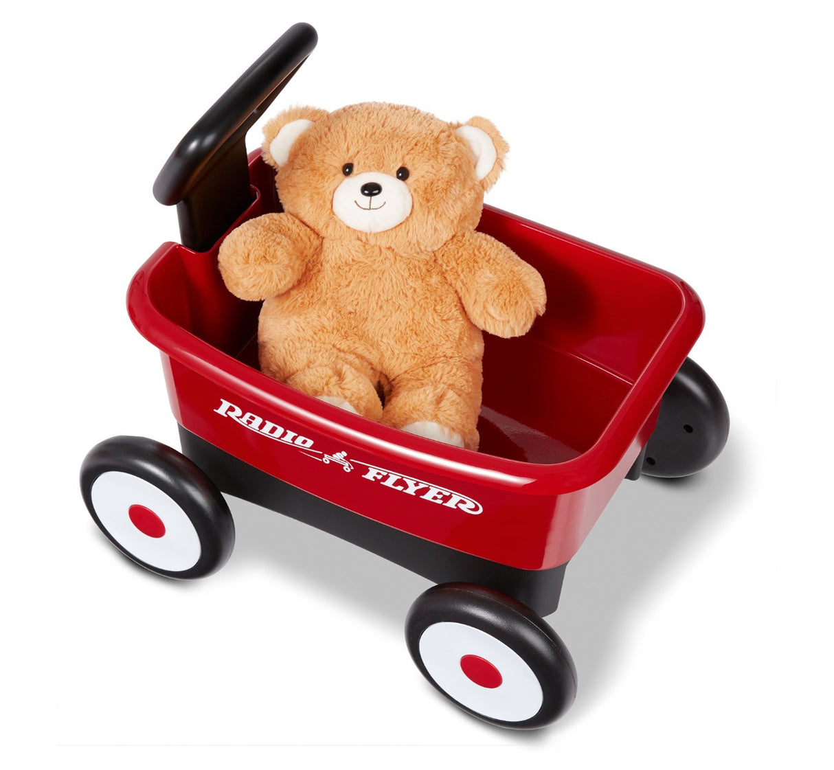 aerial angle of teddy bear inside red wagon