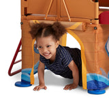 Girl crawling through Play & Fold Away Pirate Ship's secret play space underneath the platform
