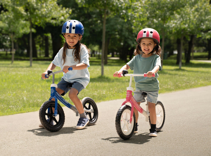 Two kids riding Radio Flyer balance bikes