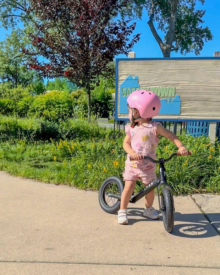 toddler riding balance bike