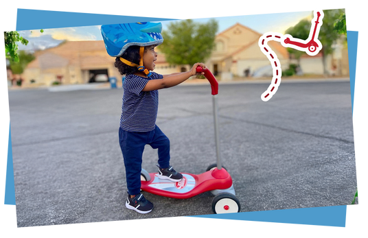 Child riding a scooter with a helmet on a paved path.