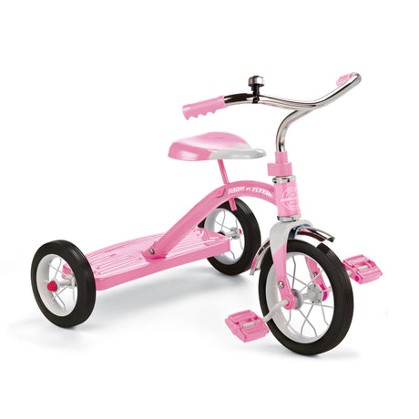 Pink classic metal tricycle on a white background