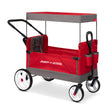 A red and gray Radio Flyer folding push wagon with a canopy, black handle, and white wheels with red centers, shown on a clean white background.