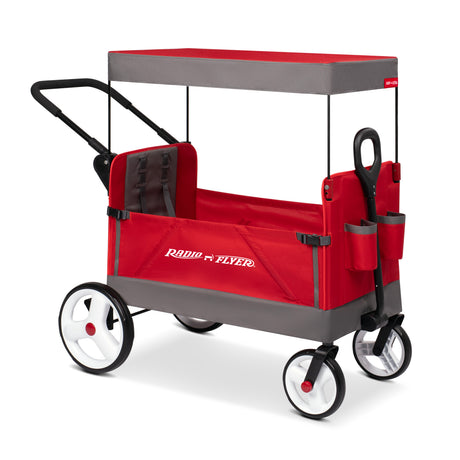 A red and gray Radio Flyer folding push wagon with a canopy, black handle, and white wheels with red centers, shown on a clean white background.