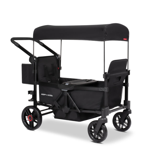 Black two kid stroller wagon with a canopy and rear storage bag on a white background