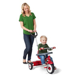 Woman pushing a toddler on a red radio flyer tricycle on a white background