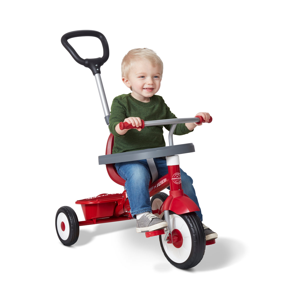 A young child sitting on a red Radio Flyer push tricycle with a black handlebar, photographed on a clean white studio background.