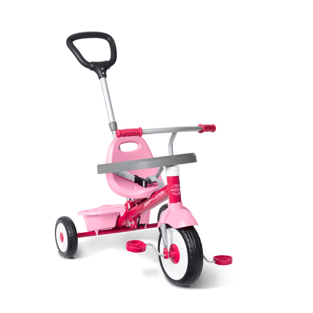 A pink and silver three-wheel tricycle with a push handlebar shown on a white background.