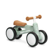 A Radio Flyer balance bike with a sage green frame, brown seat and handlebar grips, and white wheels with black tires, shown on a white background.