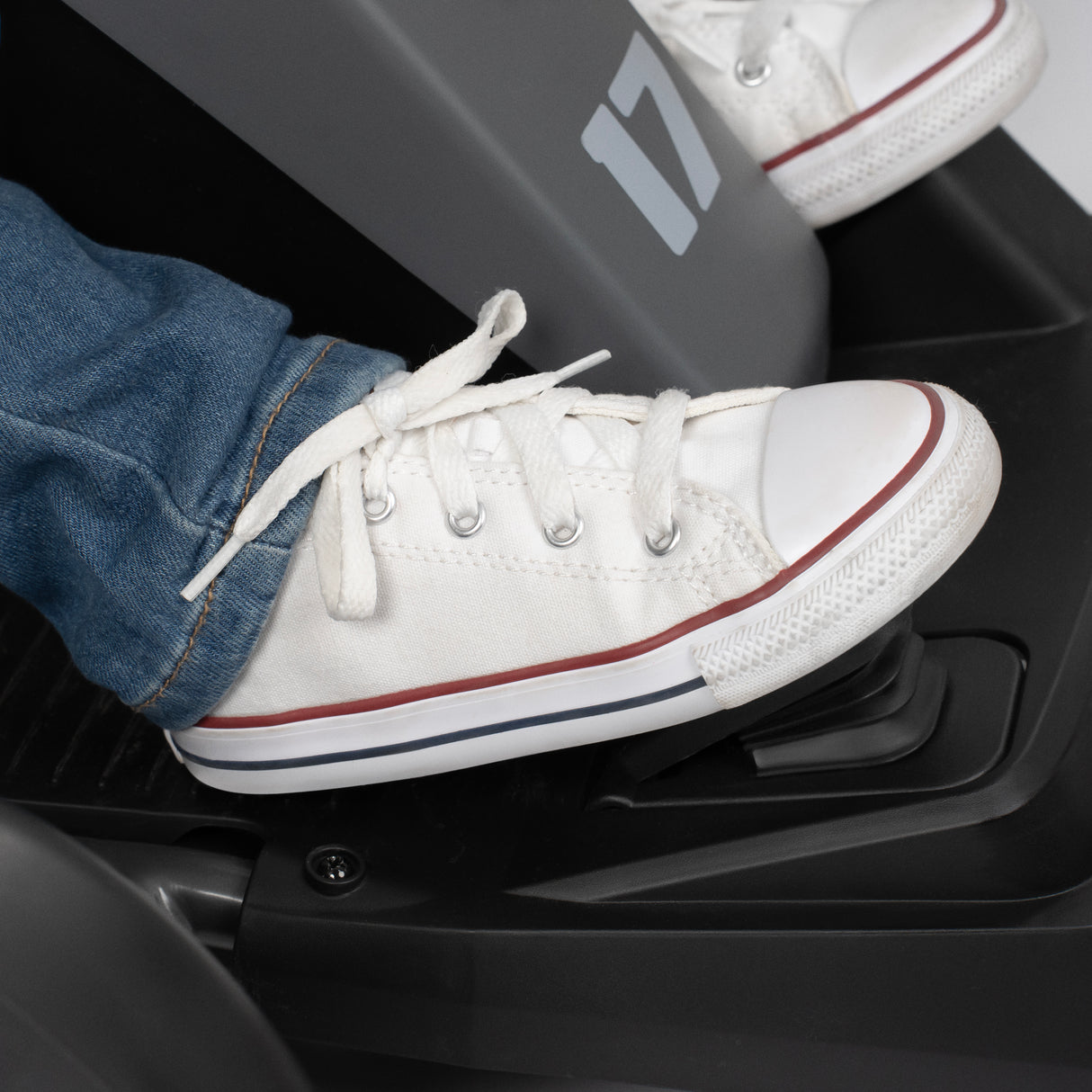Child's foot pressing down the gas pedal of the go kart