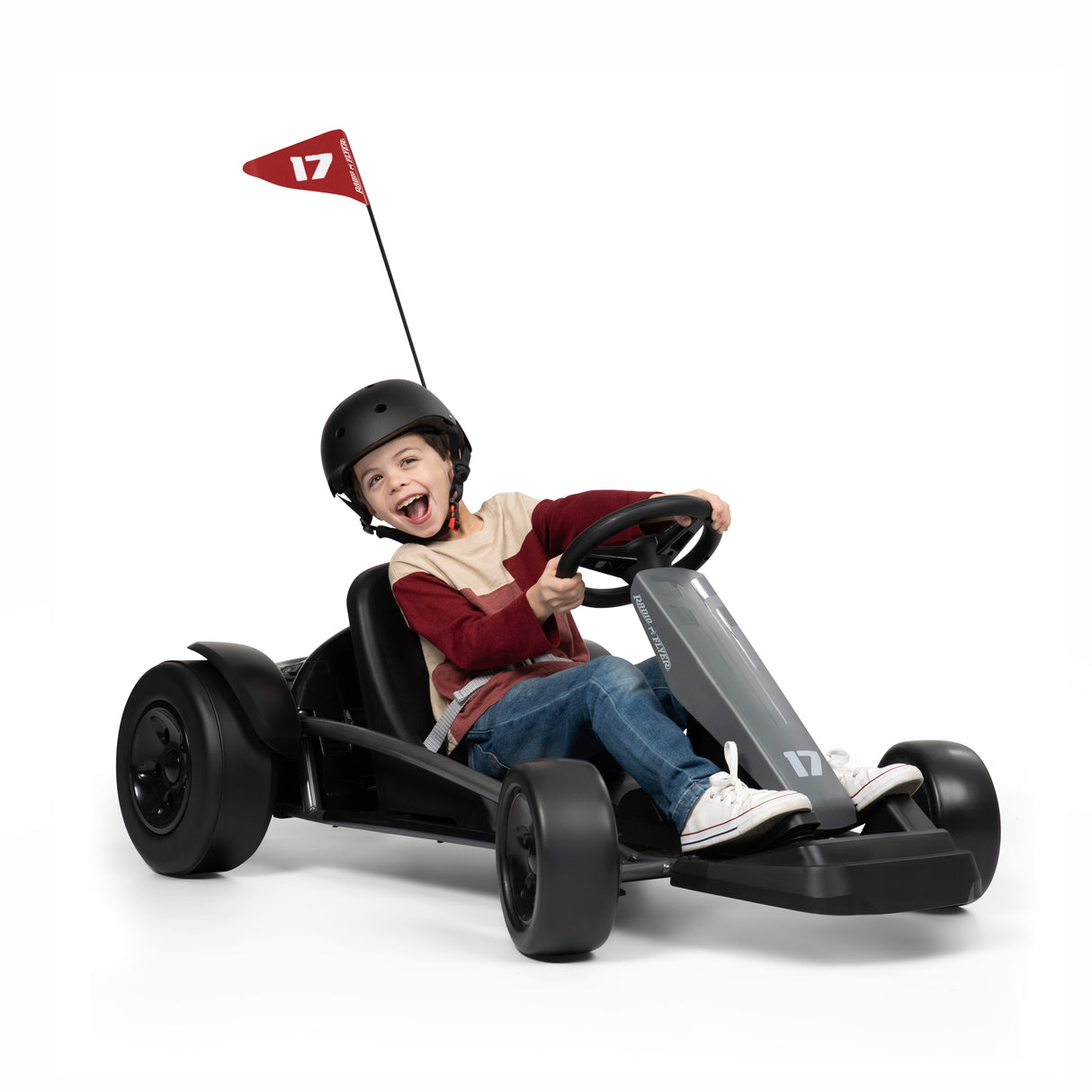 Child driving a go kart with a helmet on a white background