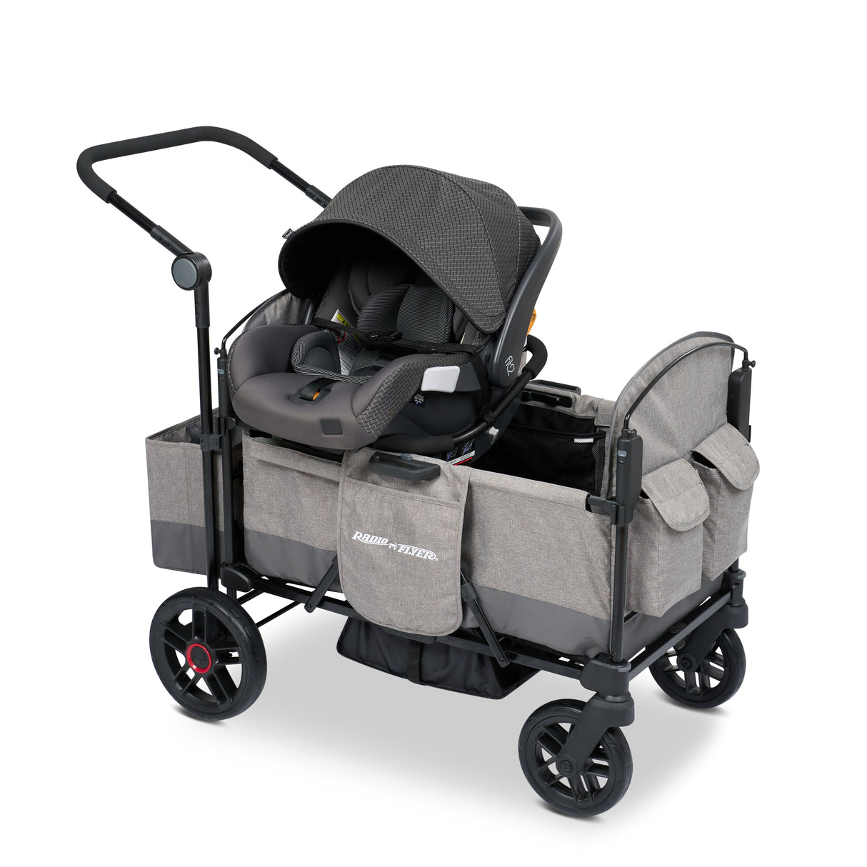 Gray stroller wagon with a car seat resting on the car seat adapter on the side walls of the wagon