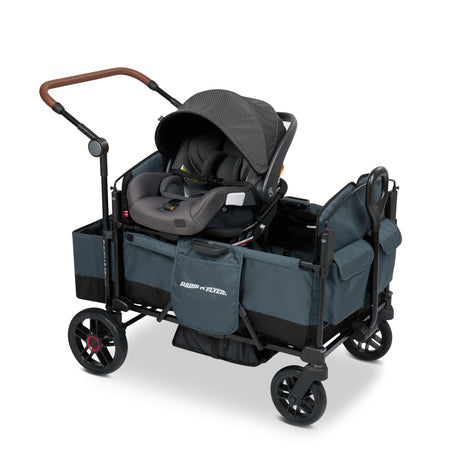 Blue stroller wagon with a car seat resting on the car seat adapter on the side walls of the wagon