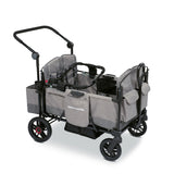 Gray stroller wagon with a car seat adapter resting on the side walls of the wagon