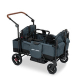 Blue stroller wagon with a car seat adapter resting on the side walls of the wagon