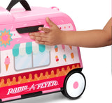 Child riding 3-in-1 Happy Trav'ler: Ice Cream Truck being pulled by parent using nylon strap