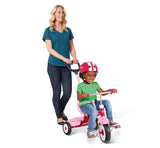 Woman pushing girl riding 3-in-1 Stroll 'N Trike® Pink in steering trike mode