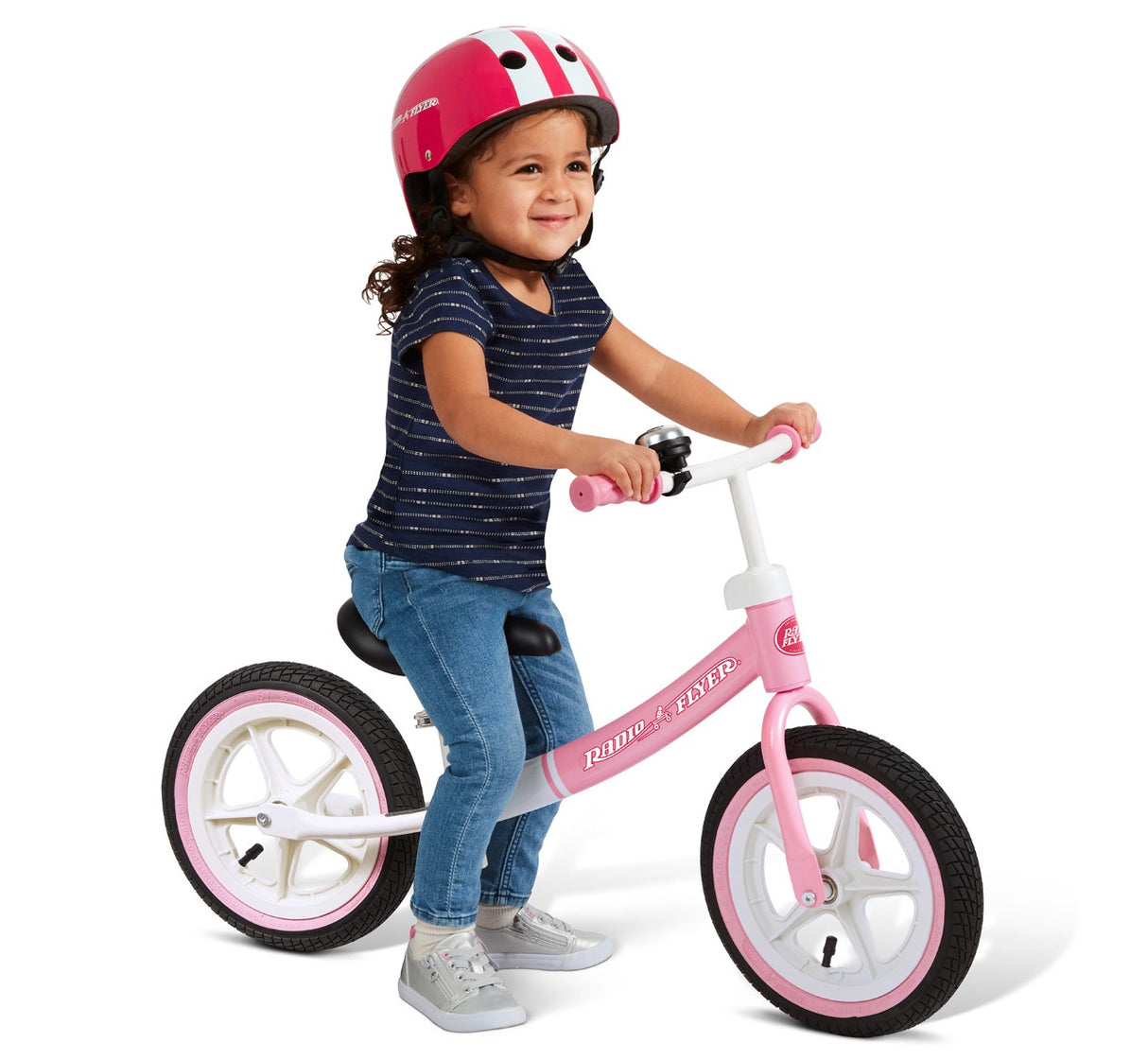 Girl Sitting On Her Air Ride Balance Bike Pink