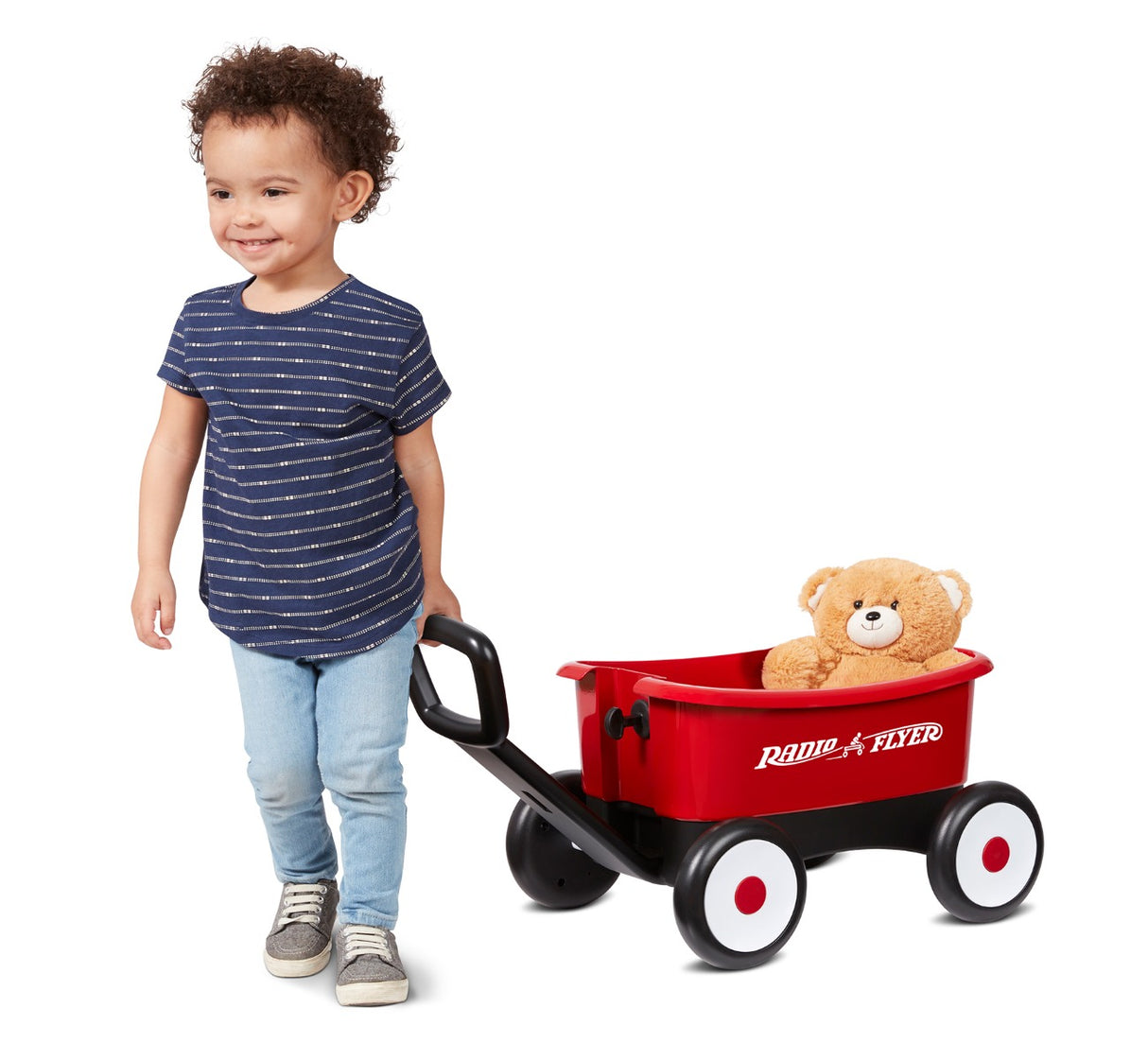 child pulling wagon with teddy bear inside