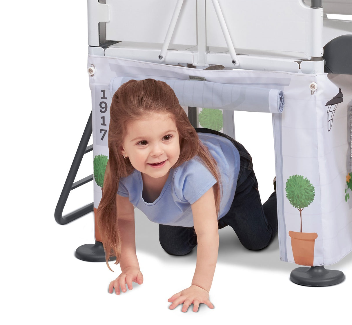 Girl crawling through secret play space underneath the platform