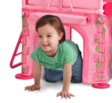 Girl crawling through secret play space underneath the platform