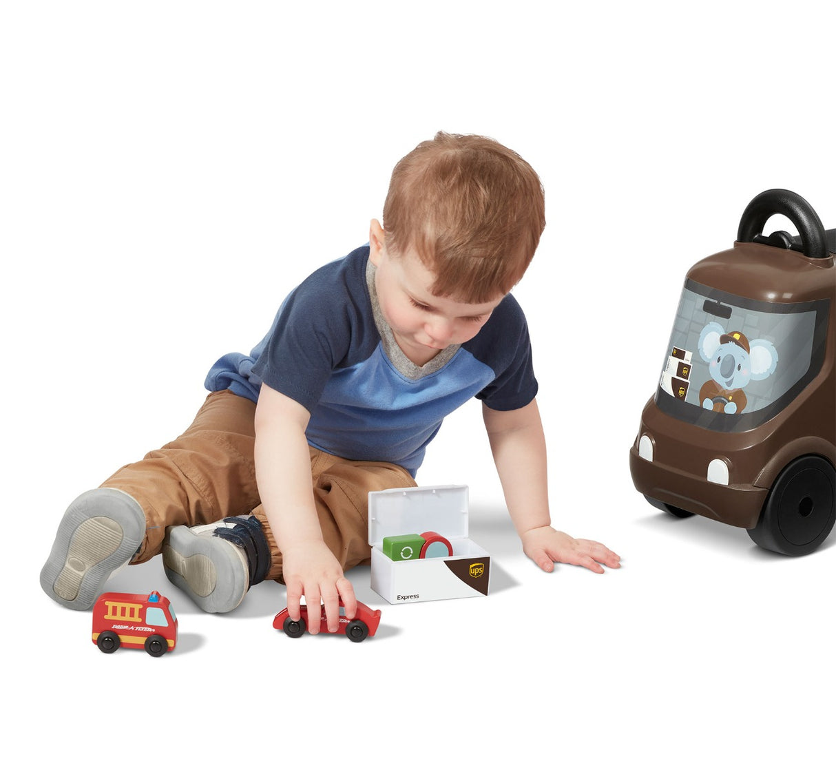 child playing with included wooden toys next to their ride on ups truck