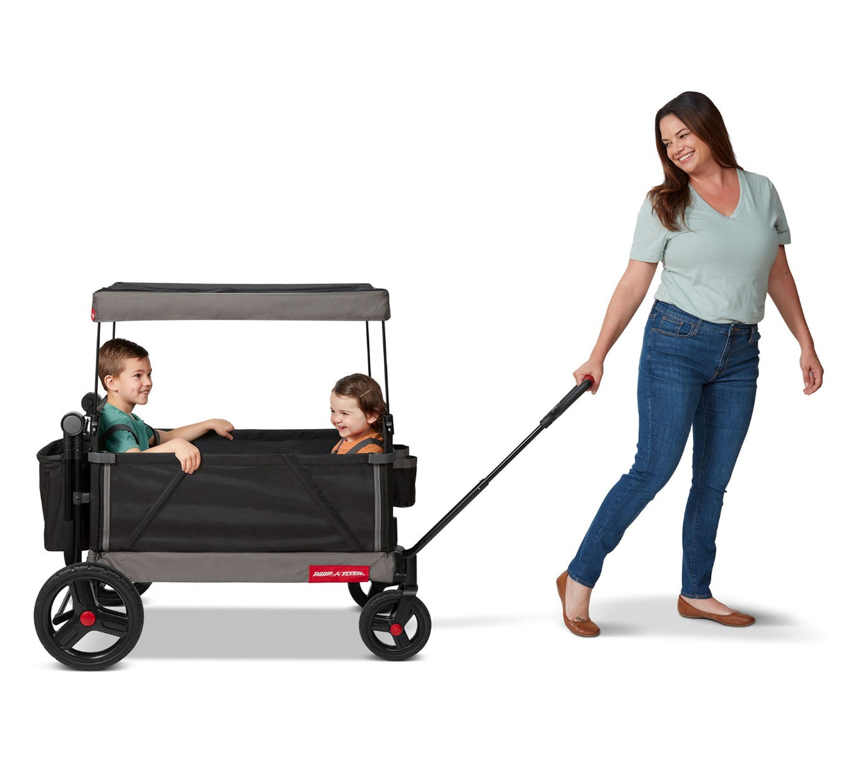 Woman Pulling Boy & Girl Riding in Trav'ler Stroll 'N Wagon™ with Protective Cover