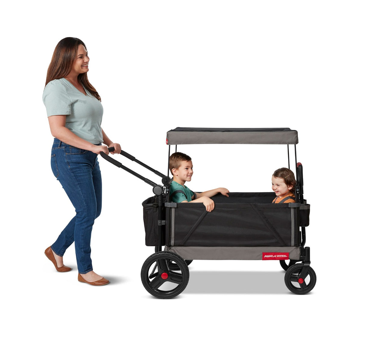 Woman Pushing Boy & Girl Riding in Trav'ler Stroll 'N Wagon™ with Protective Cover